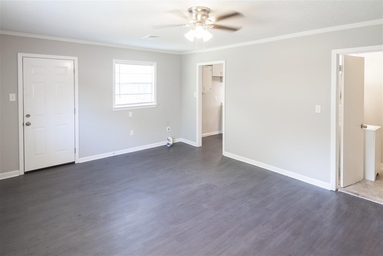 1494 Winfield Road Memphis, TN 38116 - Photo 4 of 20 a view of an empty room with a window