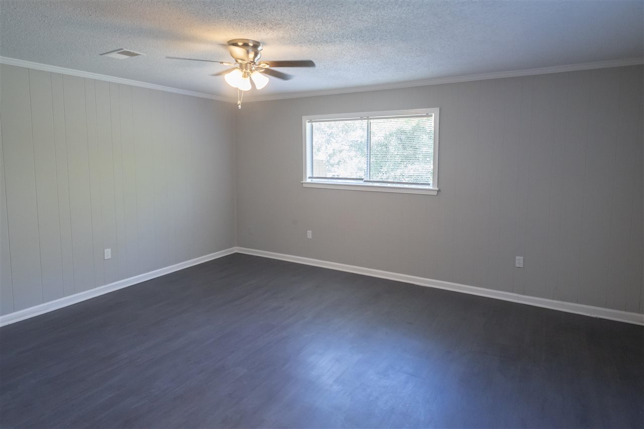1494 Winfield Road Memphis, TN 38116 - Photo 5 of 20 an empty room with a window and a ceiling fan