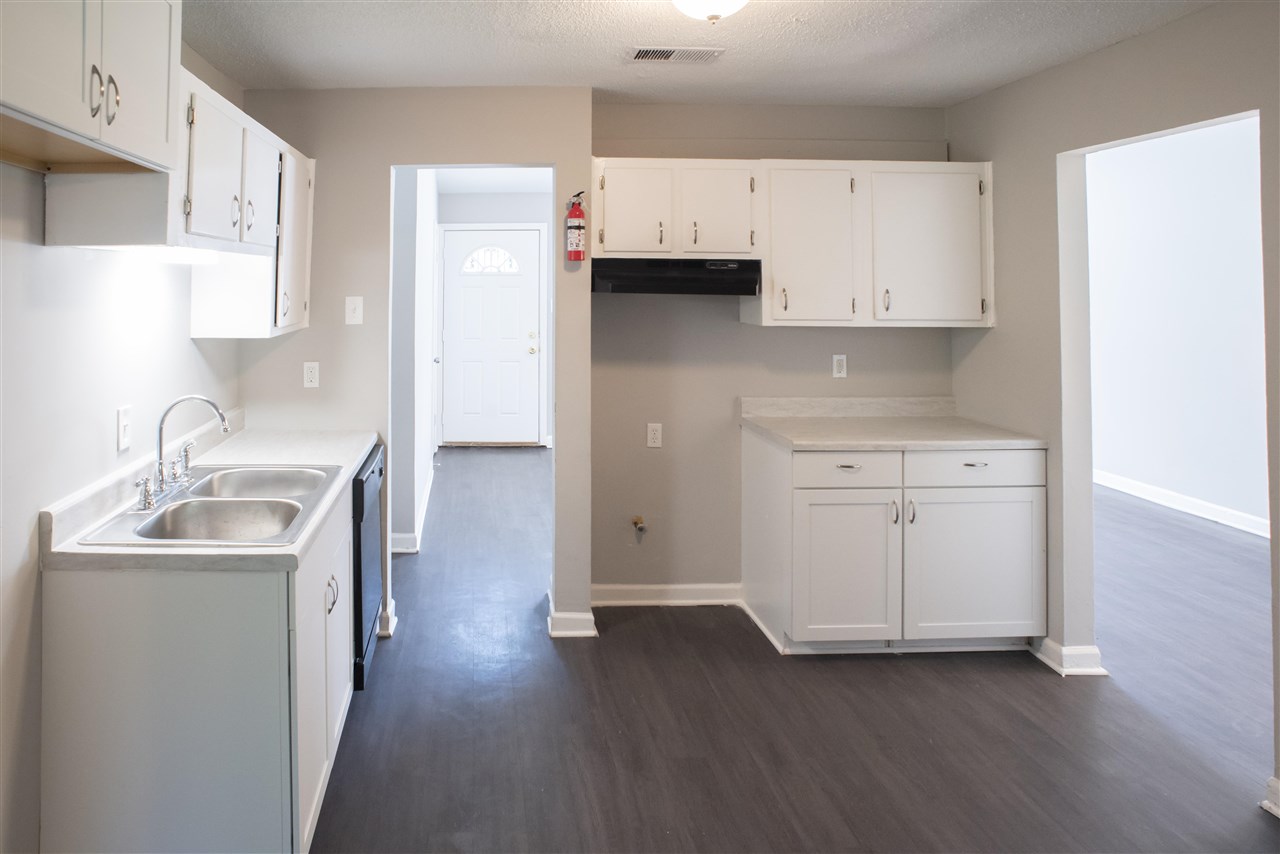 1494 Winfield Road Memphis, TN 38116 - Photo 6 of 20 a kitchen with a sink cabinets and wooden floor