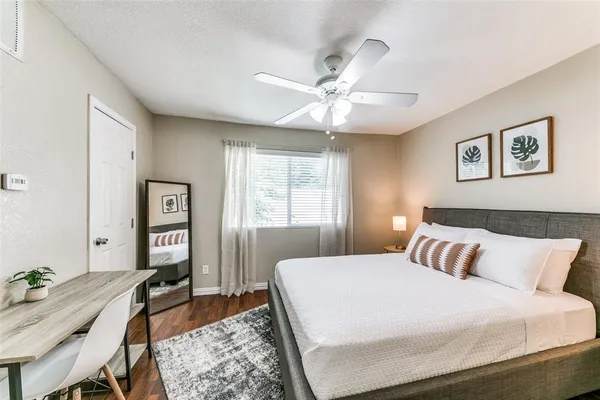 a bedroom with a bed and a chandelier
