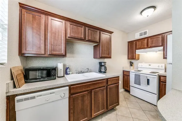 a kitchen with stainless steel appliances granite countertop a stove sink and cabinets