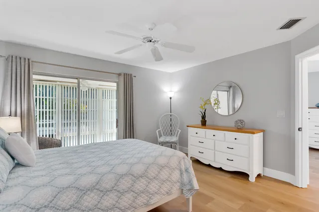 a bedroom with a bed and a ceiling fan