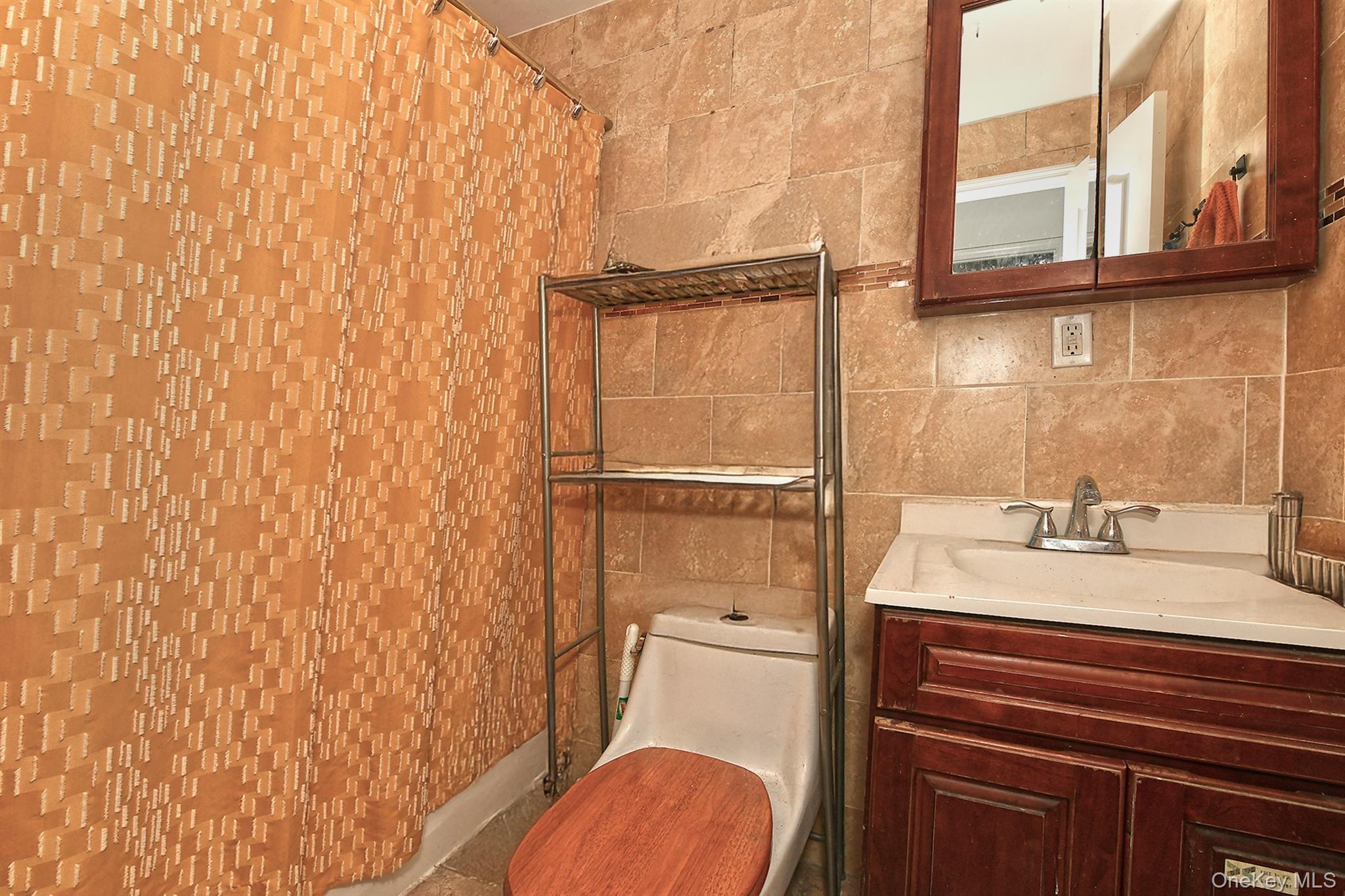 1244 Jefferson Avenue Brooklyn, NY 11221 - Photo 15 of 21 a bathroom with a granite countertop sink toilet and a mirror