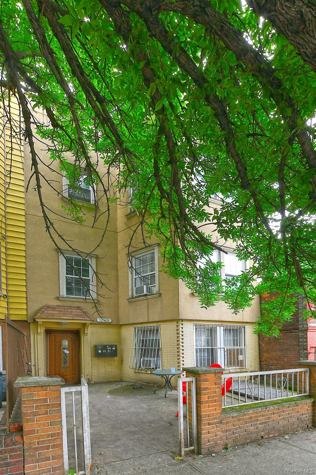 1244 Jefferson Avenue Brooklyn, NY 11221 - Photo 2 of 21 a view of a house with large tree and wooden fence