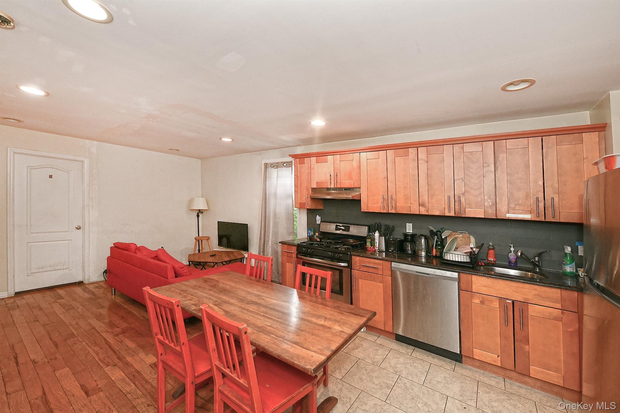 1244 Jefferson Avenue Brooklyn, NY 11221 - Photo 4 of 21 a kitchen with stainless steel appliances granite countertop a stove a sink dishwasher and a microwave with wooden cabinets