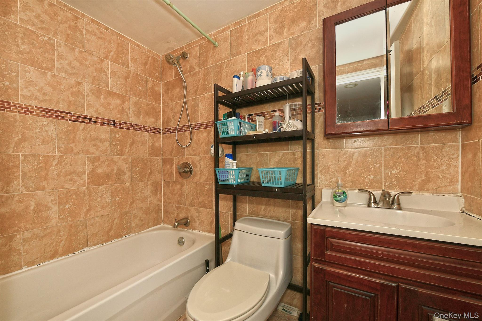1244 Jefferson Avenue Brooklyn, NY 11221 - Photo 6 of 21 a bathroom with a sink a toilet and bathtub