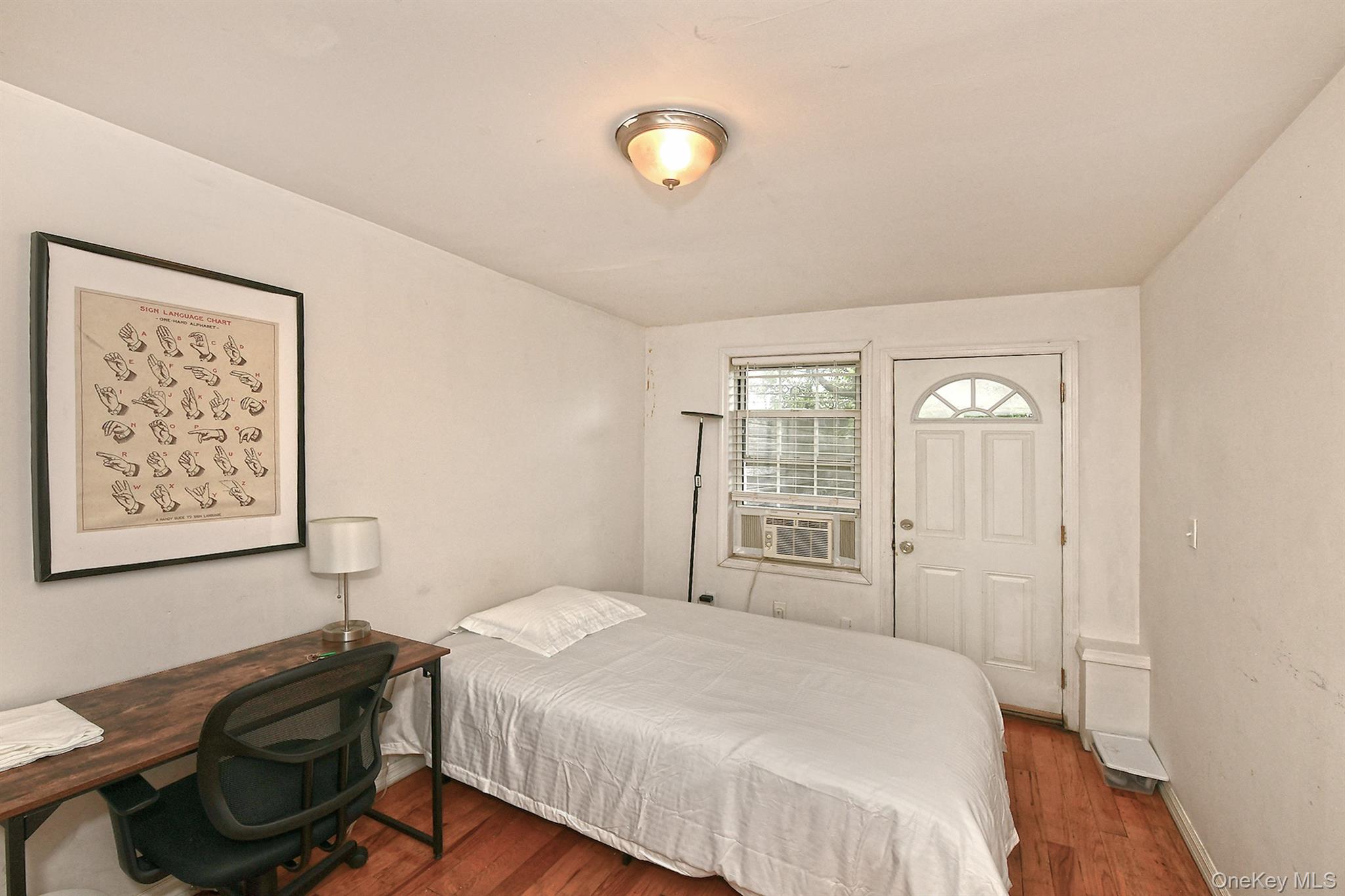 1244 Jefferson Avenue Brooklyn, NY 11221 - Photo 7 of 21 a bedroom with a bed and a window