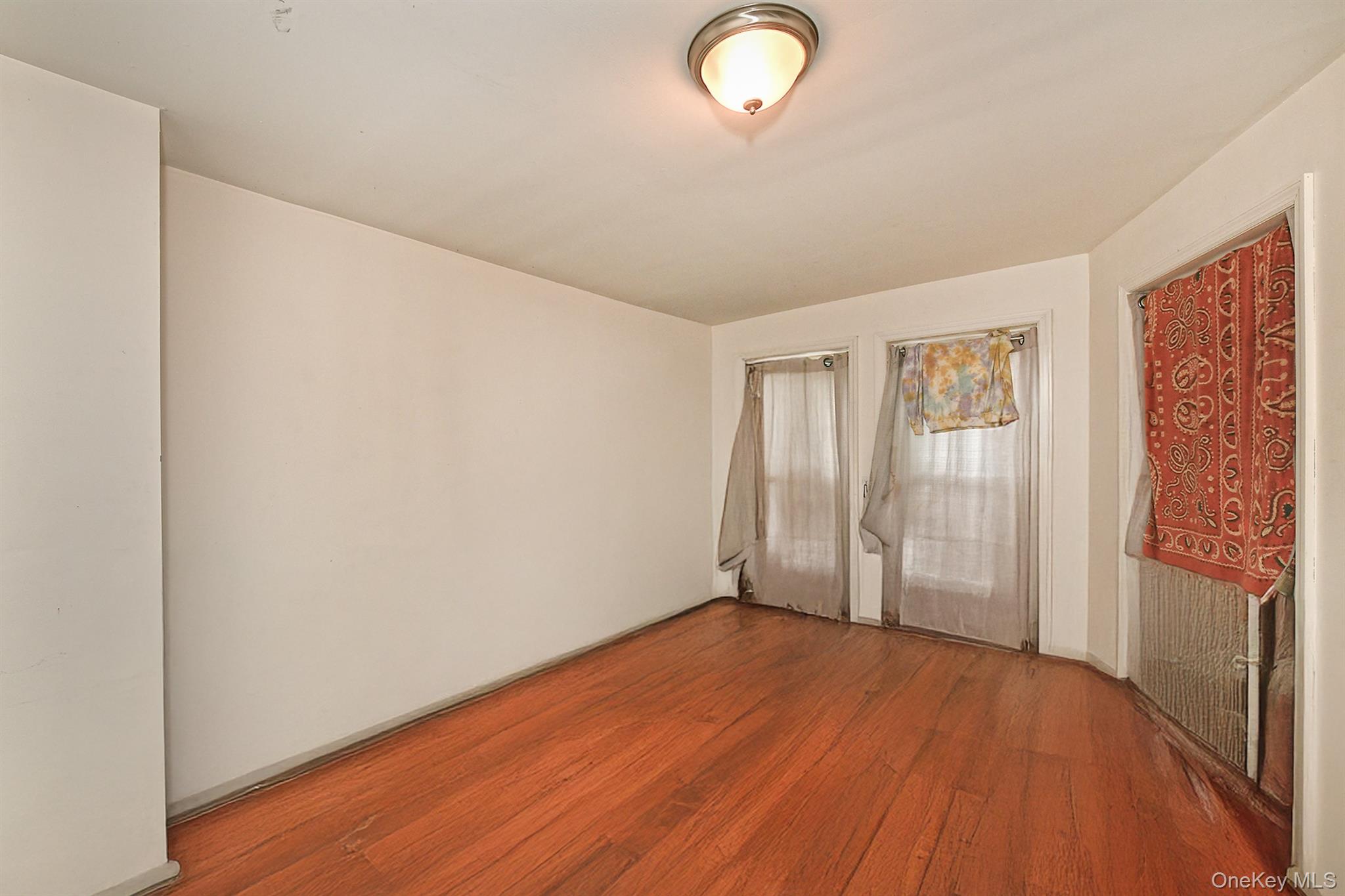 1244 Jefferson Avenue Brooklyn, NY 11221 - Photo 9 of 21 an empty room with wooden floor and windows