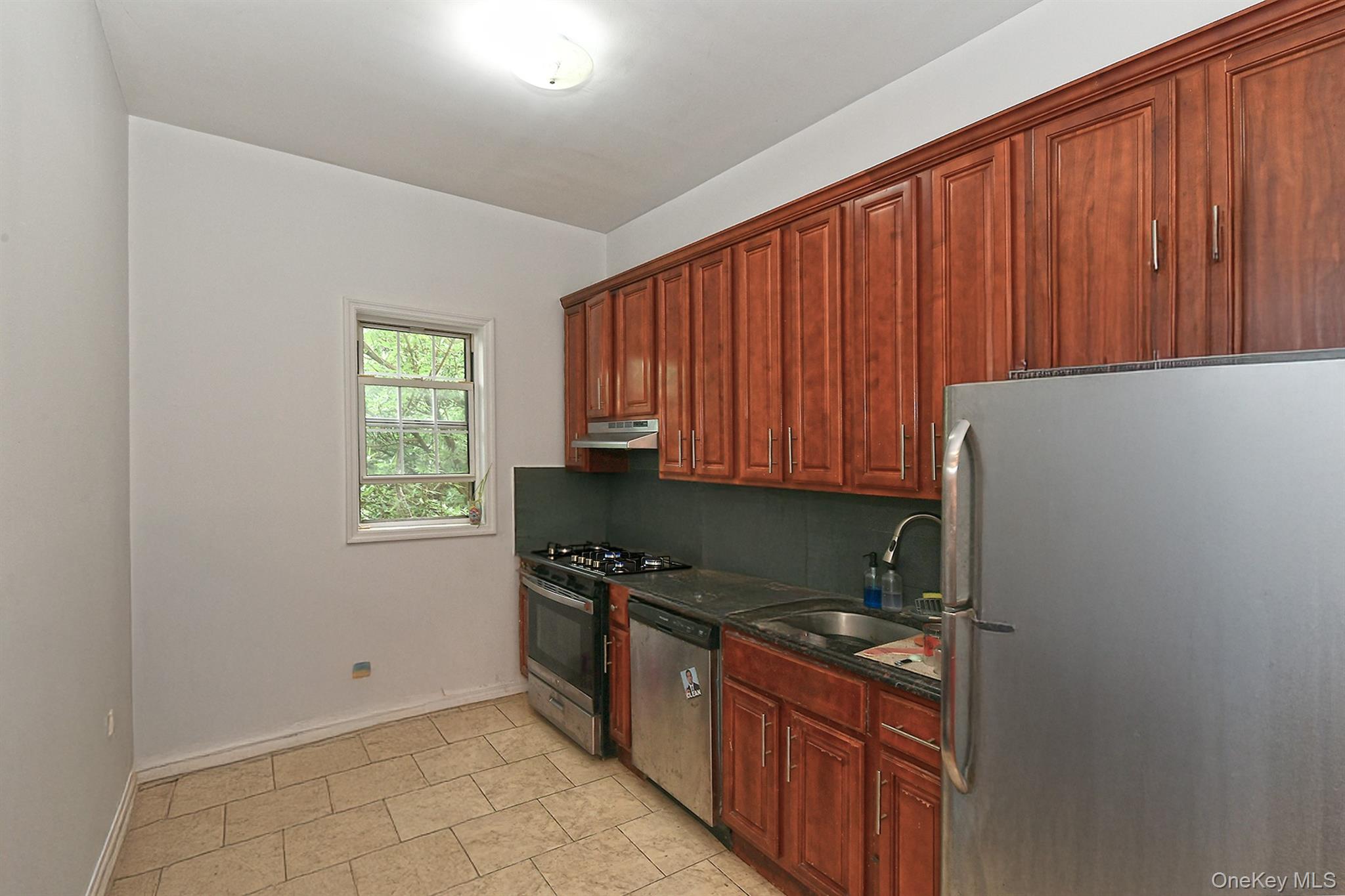 1244 Jefferson Avenue Brooklyn, NY 11221 - Photo 10 of 21 a kitchen with granite countertop cabinets and black appliances