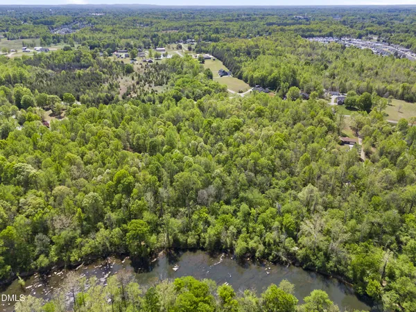 an aerial view of a houses with a yard