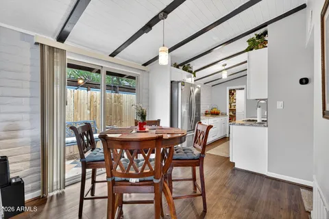 a view of a dining room with furniture and window