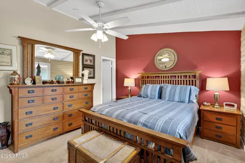 a bedroom with a bed and a dresser in it