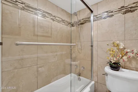a bathroom with a shower a toilet and a sink