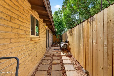 a backyard of a house with table and chairs