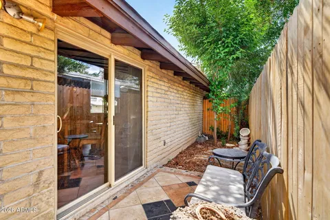 a view of backyard with outdoor seating and stairs