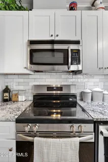 a stove top oven sitting inside of a kitchen