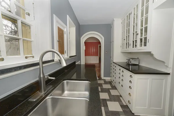 a close view of a sink and cabinets
