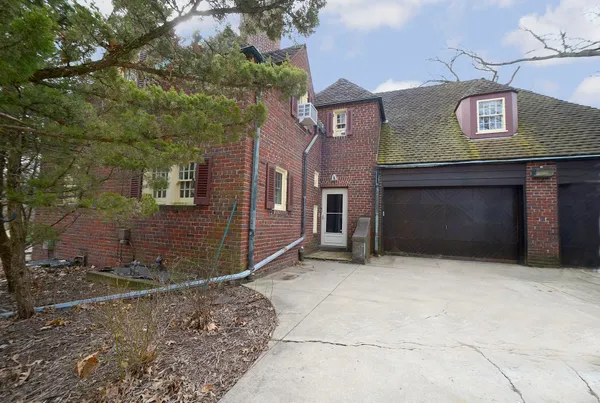 a front view of a house with parking space