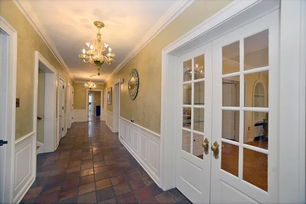 a room with lots of wooden furniture and windows