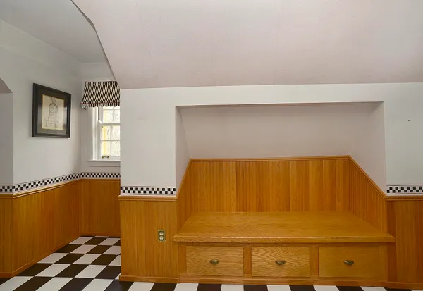 a bed sitting in a bedroom next to a window