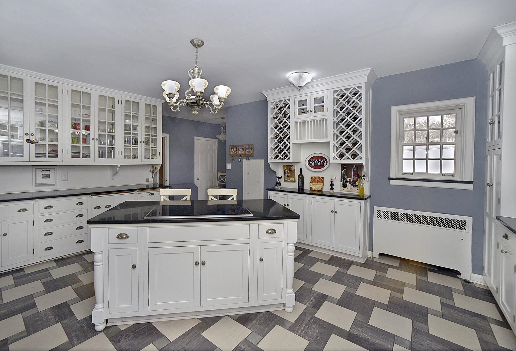 2221 Twin Oak Road Peru, IL 61354 - Photo 52 of 63 a kitchen with granite countertop a stove a sink and a chandelier