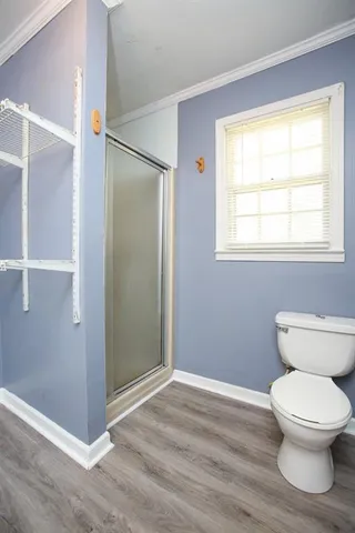 a bathroom with a toilet and a shower
