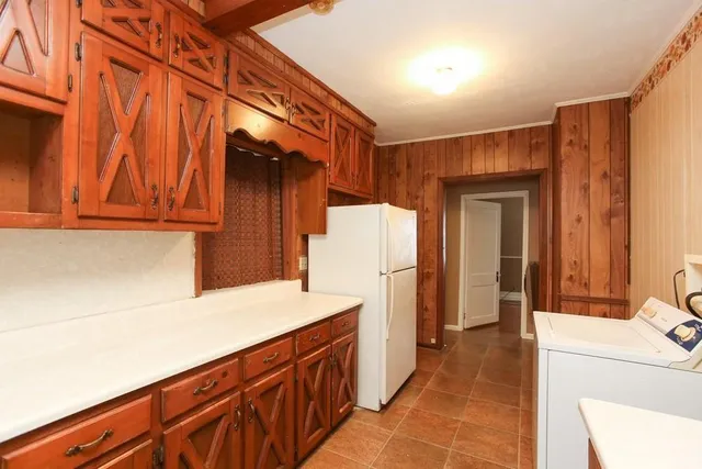 a kitchen with stainless steel appliances a refrigerator and a stove top oven