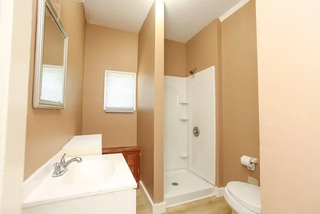 a bathroom with a sink toilet and shower