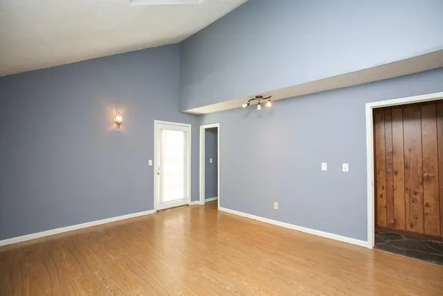 an empty room with closet and a chandelier fan