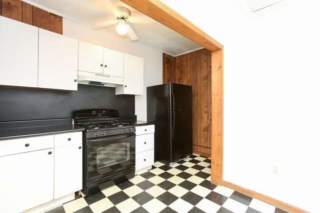 a kitchen with granite countertop a refrigerator and a stove