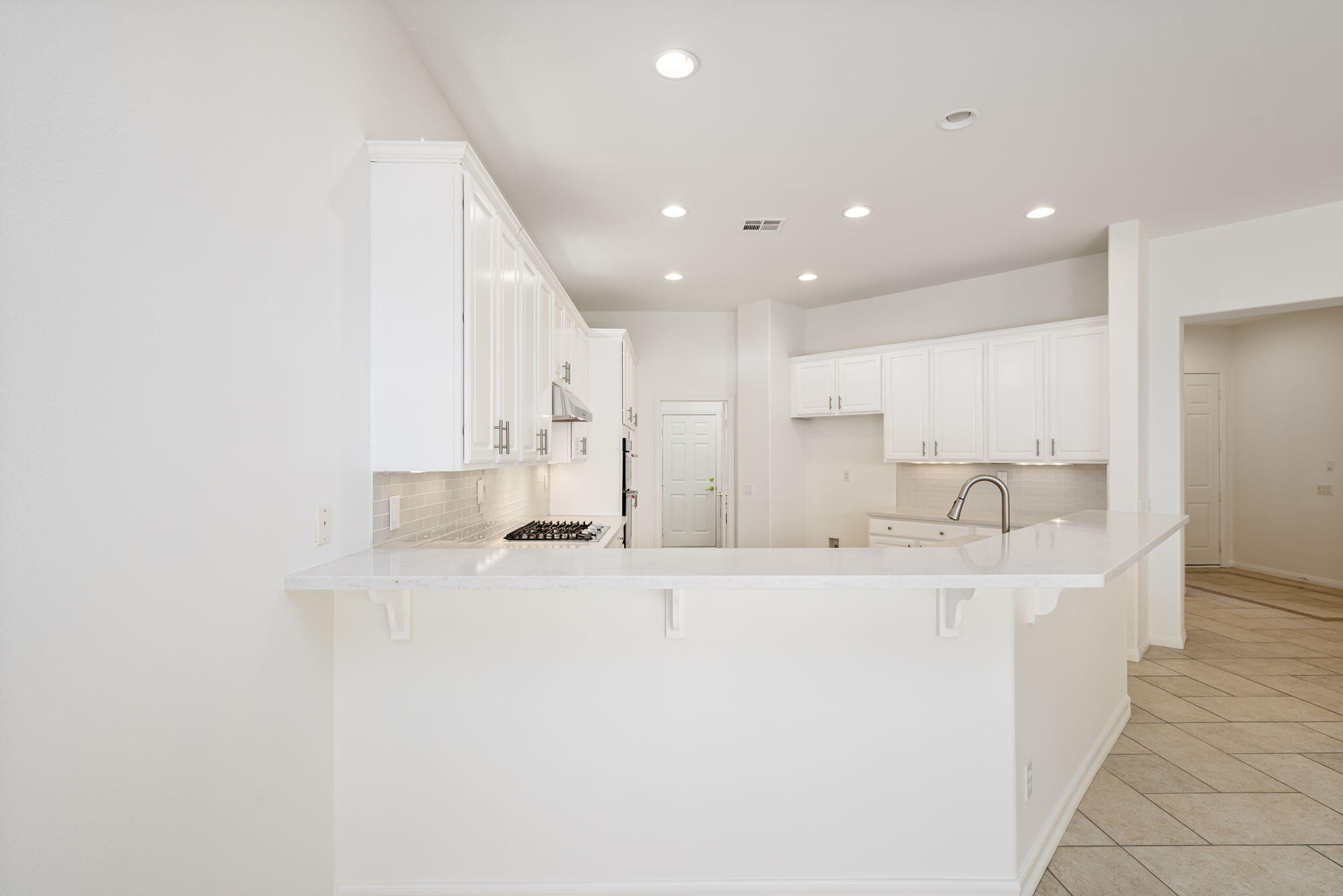 44528 Knightswood Road Indio, CA 92201 - Photo 16 of 46 a view of a kitchen with kitchen island a sink stainless steel appliances and cabinets