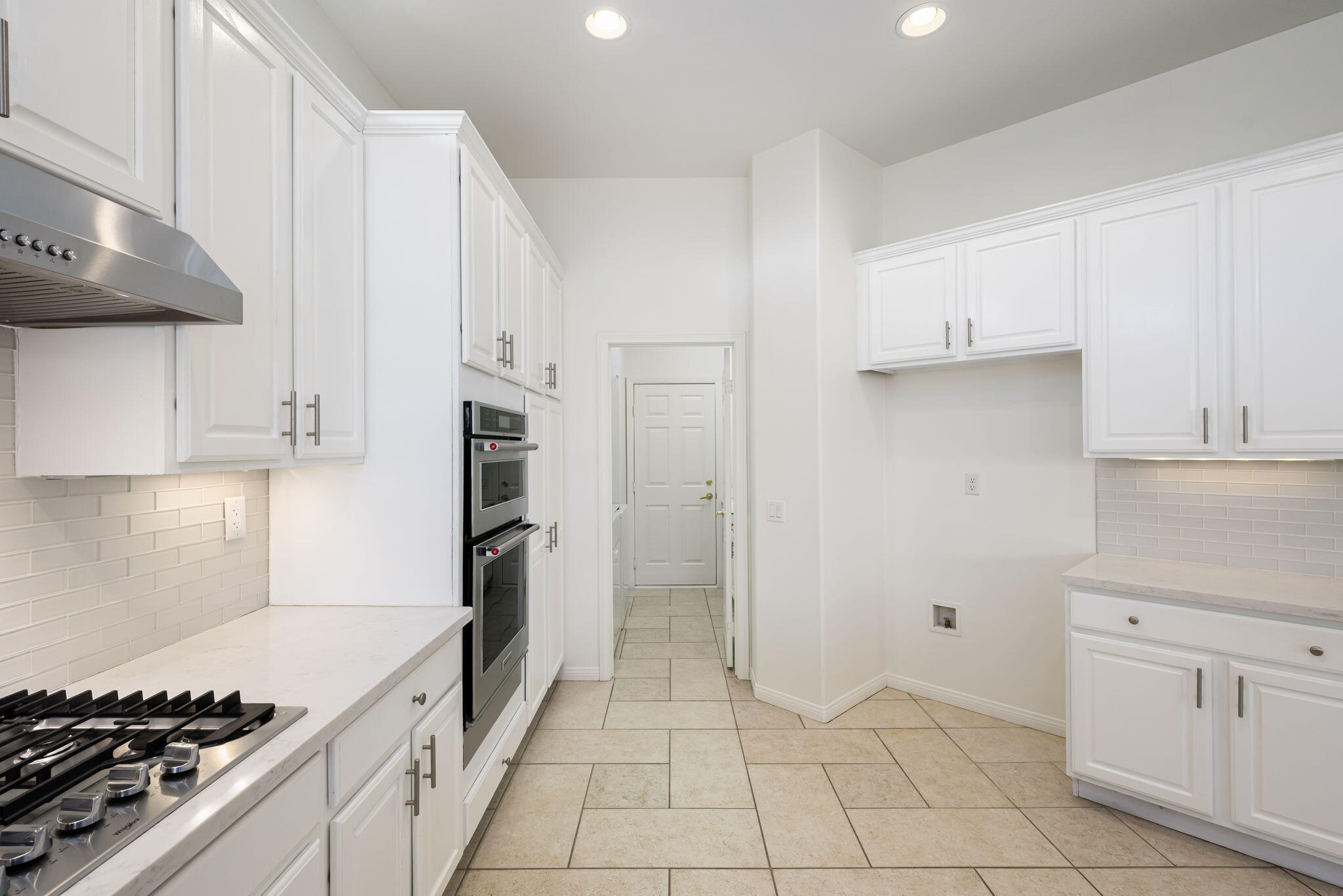 44528 Knightswood Road Indio, CA 92201 - Photo 19 of 46 a kitchen with white cabinets and appliances