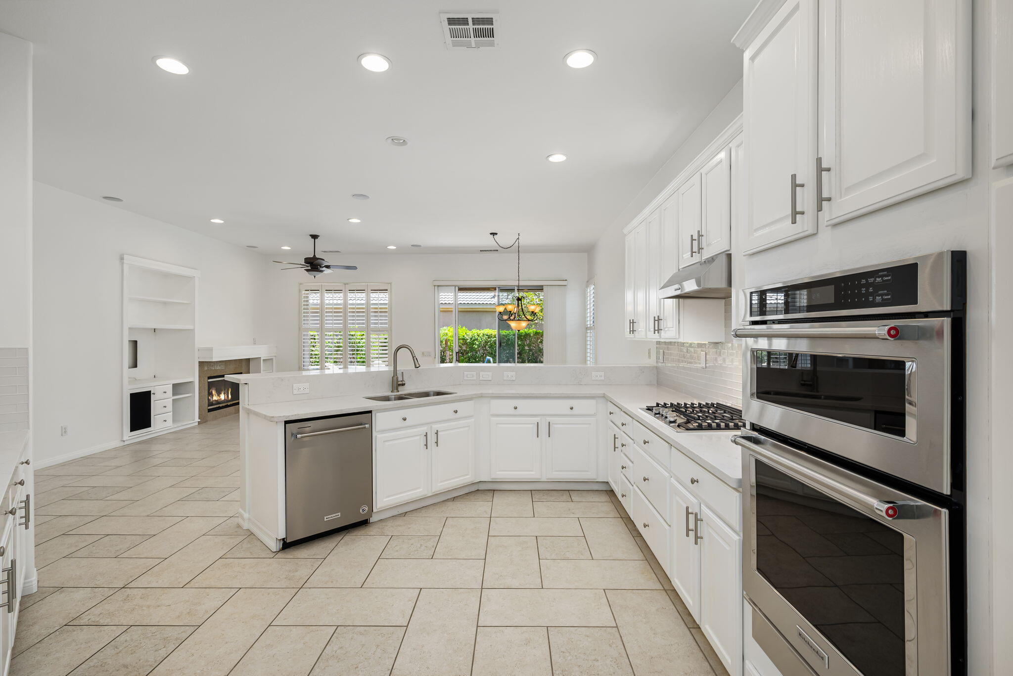 44528 Knightswood Road Indio, CA 92201 - Photo 21 of 46 a kitchen with a stove sink and cabinets
