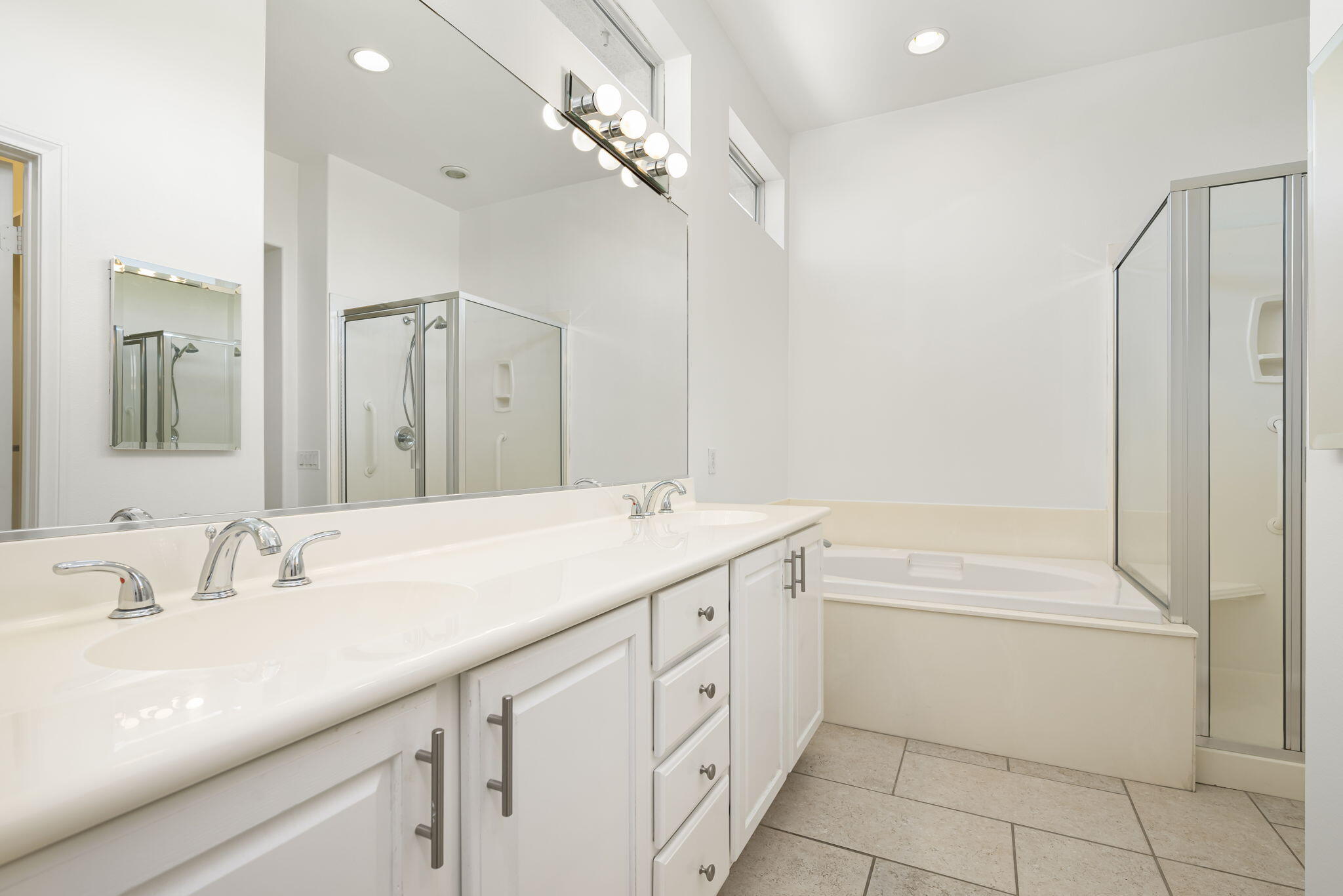 44528 Knightswood Road Indio, CA 92201 - Photo 25 of 46 a bathroom with a sink a vanity and a mirror