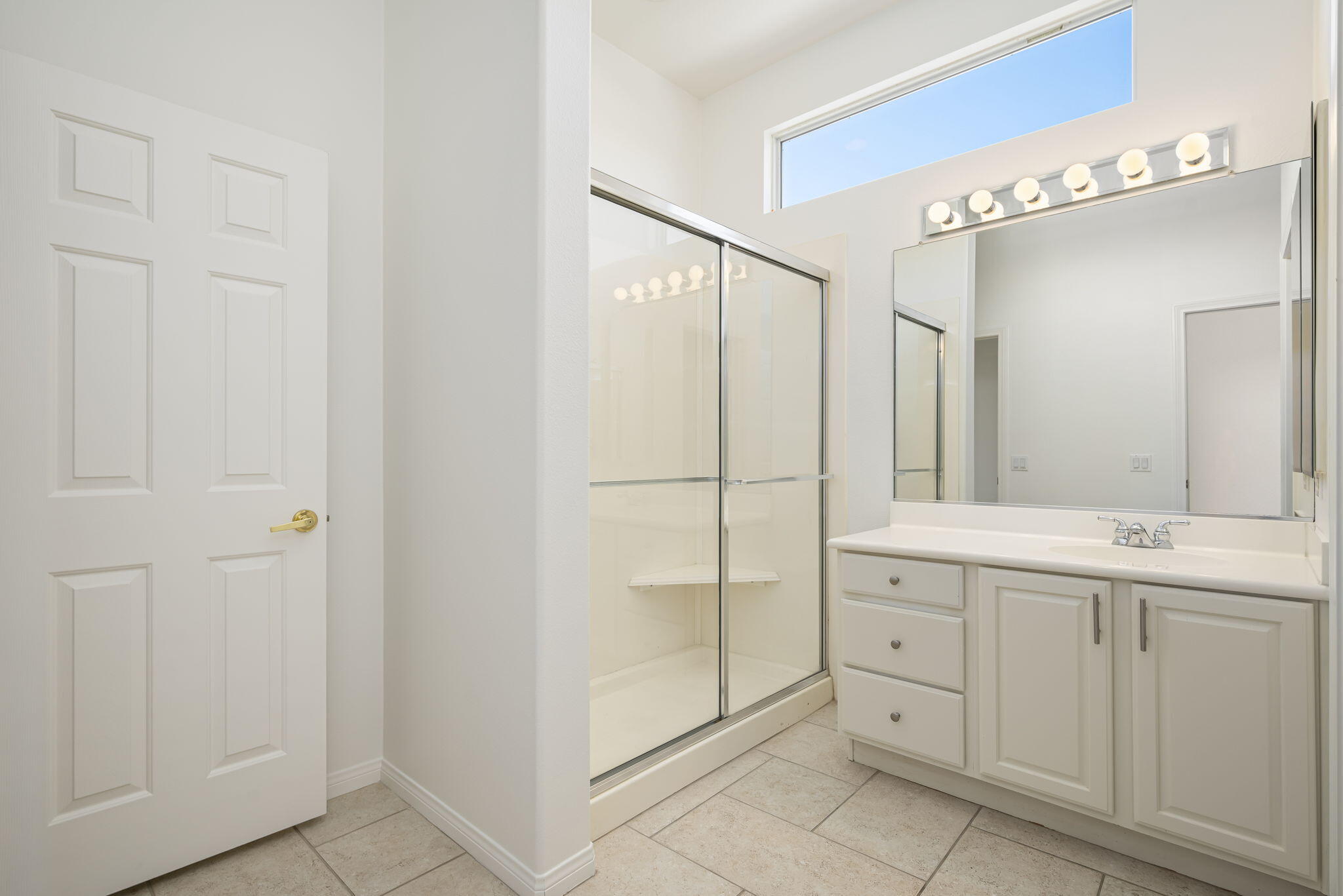 44528 Knightswood Road Indio, CA 92201 - Photo 29 of 46 a bathroom with a double vanity sink and mirror
