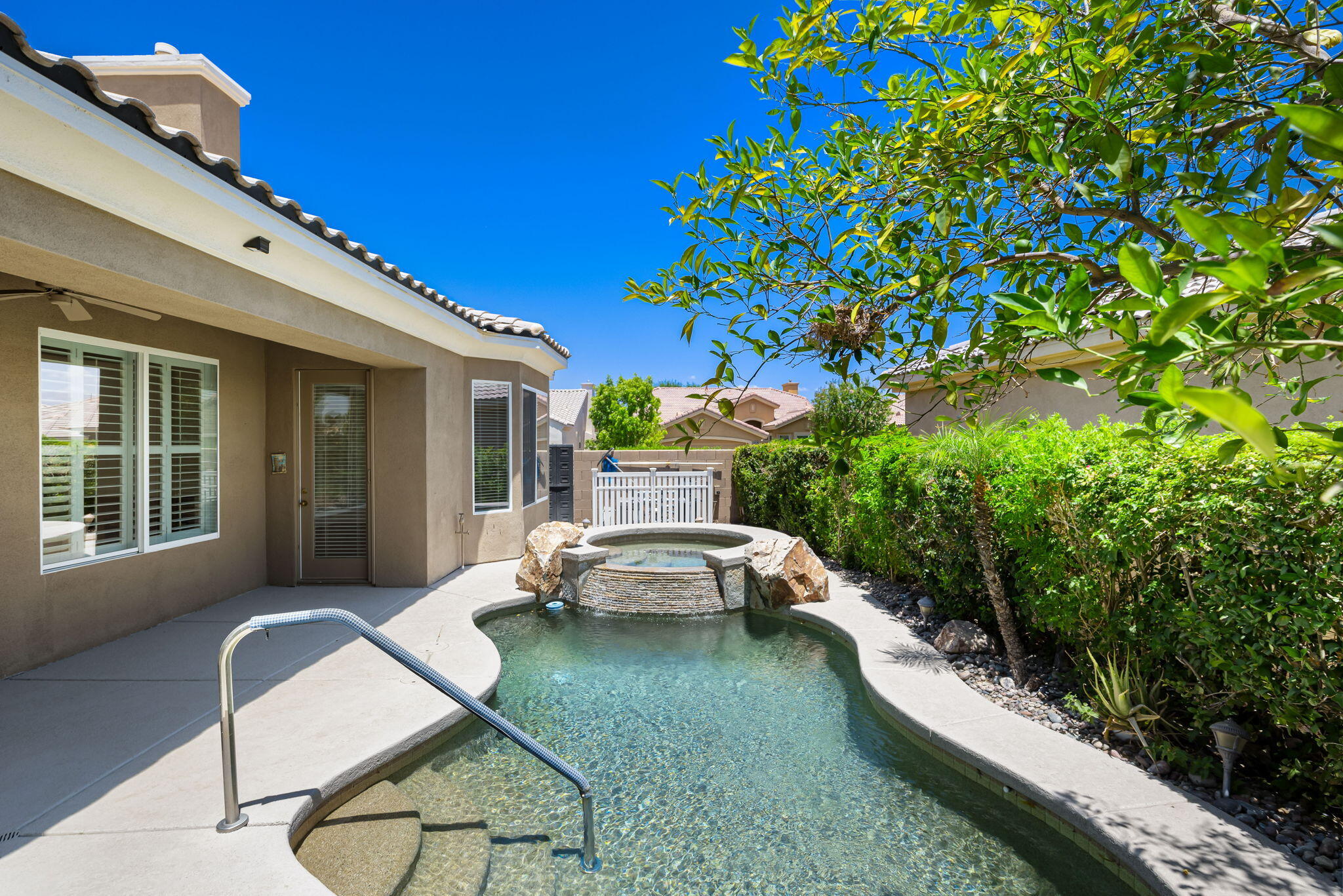 44528 Knightswood Road Indio, CA 92201 - Photo 35 of 46 a view of a patio with couches table and chairs and potted plants