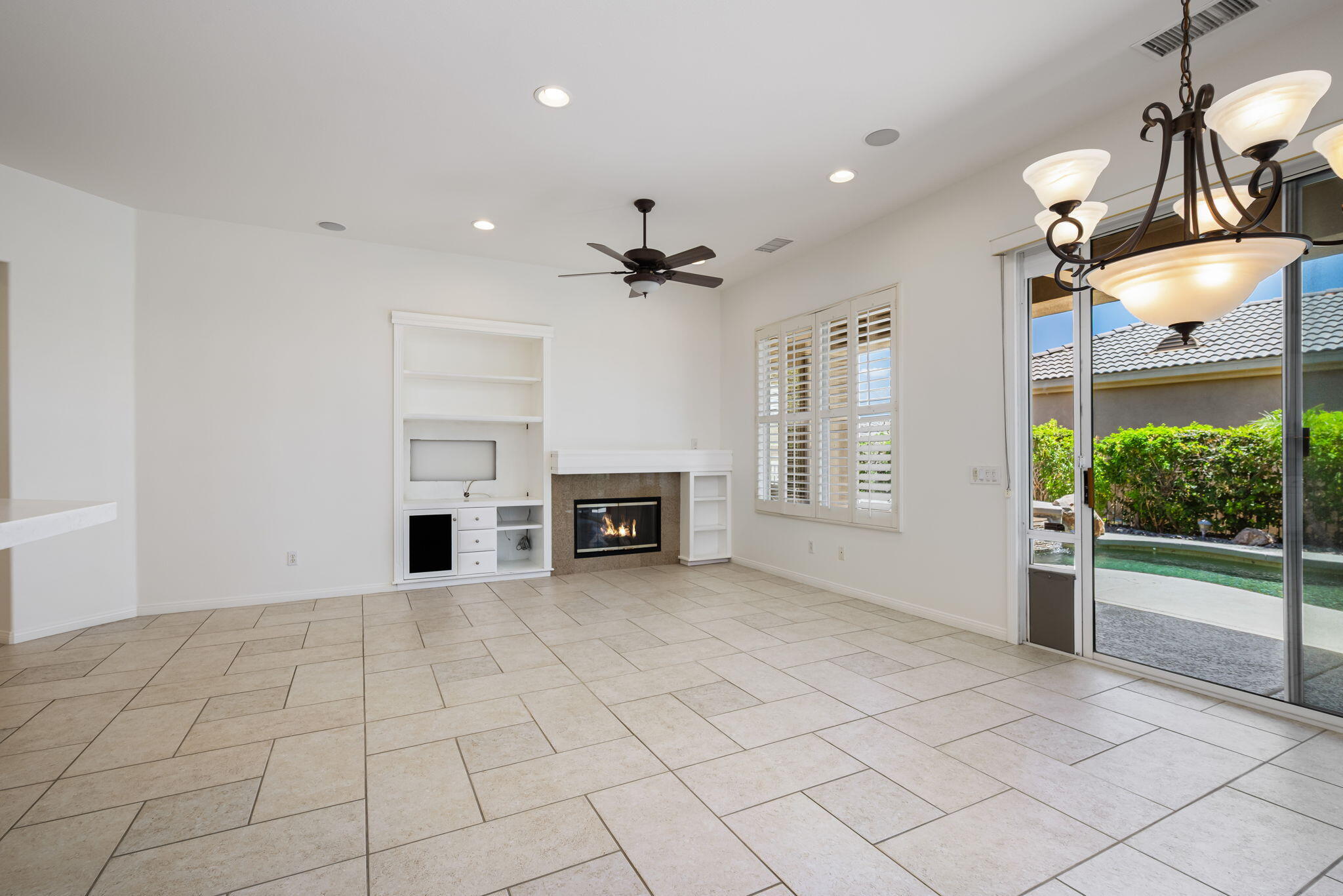 44528 Knightswood Road Indio, CA 92201 - Photo 10 of 46 an empty room with fireplace and windows