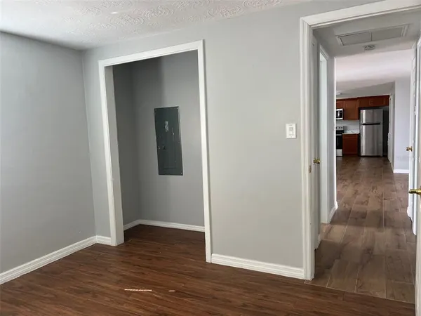 a view of a hallway with wooden floor