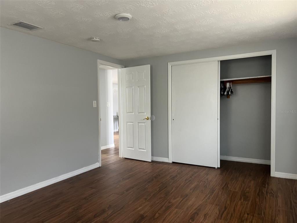 5046 Victoria Lane Holiday, FL 34690 - Photo 15 of 24 a view of an empty room with wooden floor and closet