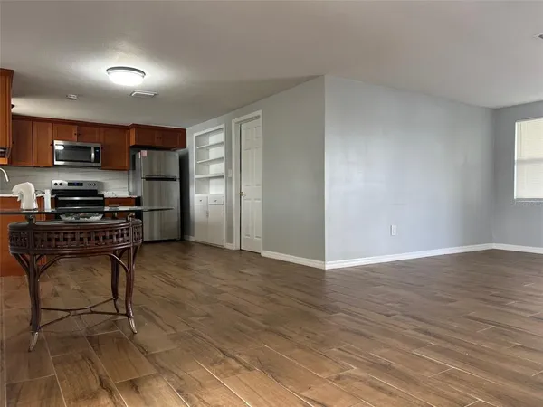 a kitchen with stainless steel appliances a refrigerator and a stove top oven