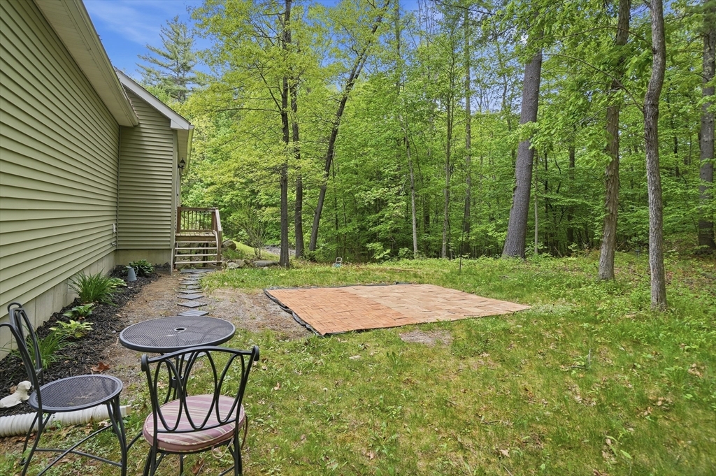 186 Common Street Groton, MA 01450 - Photo 26 of 28 a backyard of a house with table and chairs