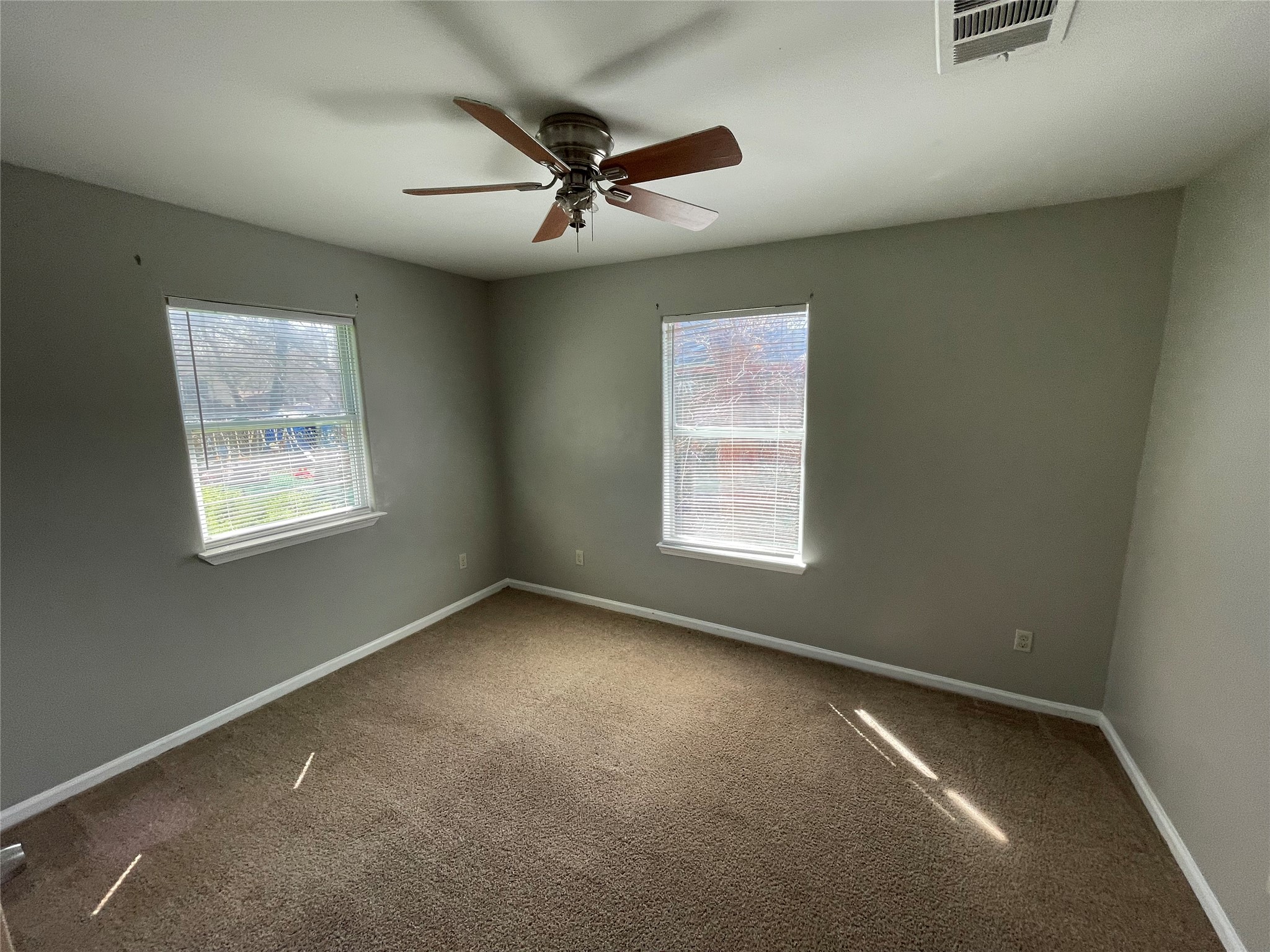 1041 Lott Avenue Austin, TX 78721 - Photo 9 of 14 an empty room with windows and fan