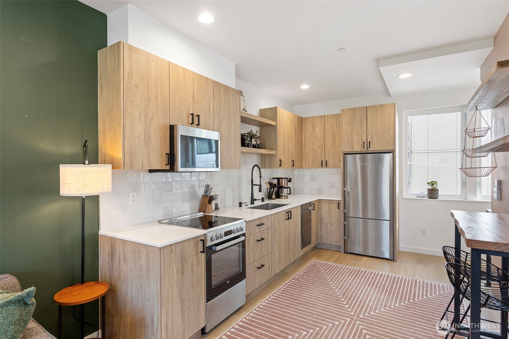8455 Delridge Way Southwest Seattle, WA 98106 - Photo 9 of 20 a kitchen with stainless steel appliances a refrigerator a sink a stove a table and chairs