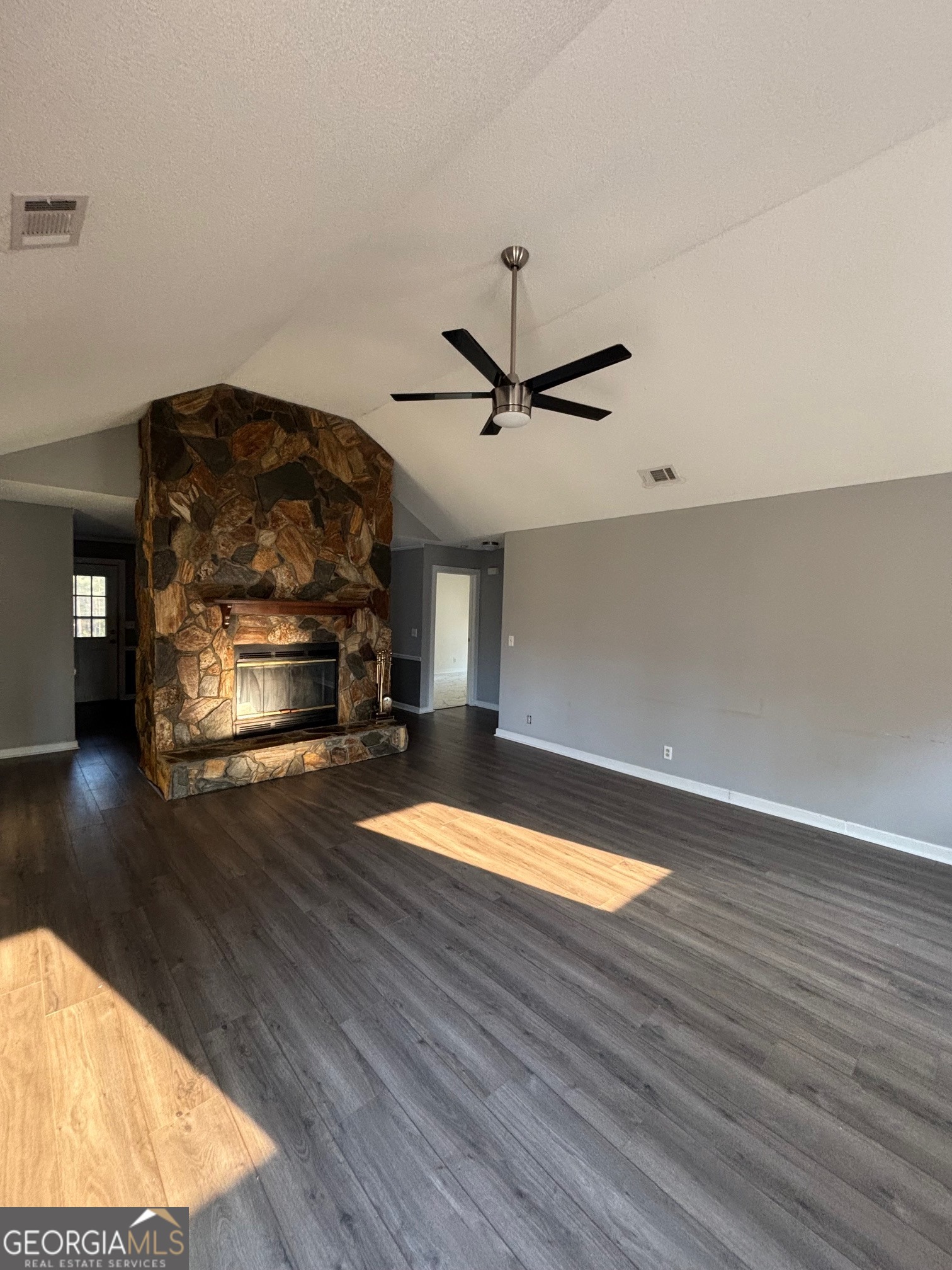 121 Girl Scout Road Lizella, GA 31052 - Photo 2 of 11 a living room with hard wood floors and a ceiling fan