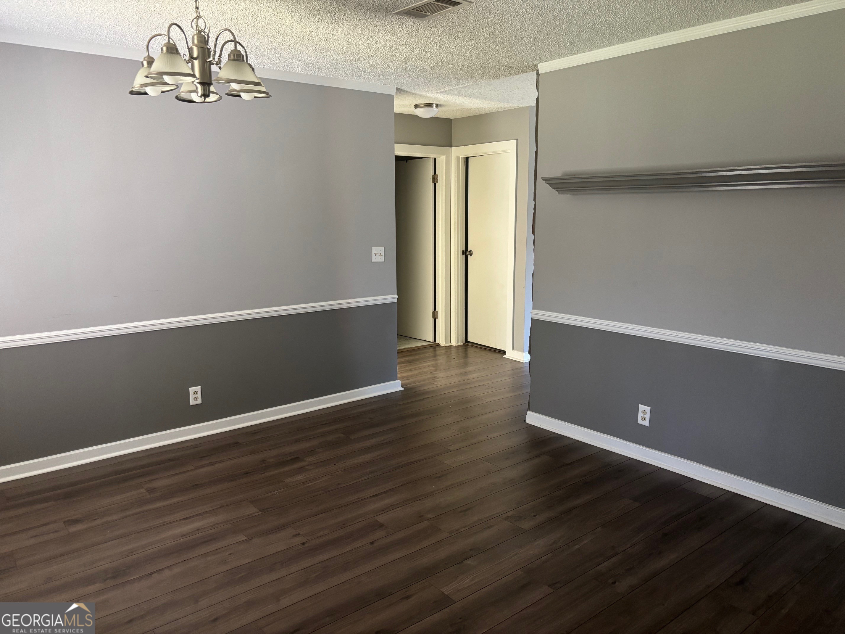 121 Girl Scout Road Lizella, GA 31052 - Photo 3 of 11 a view of an empty room with wooden floor and a window