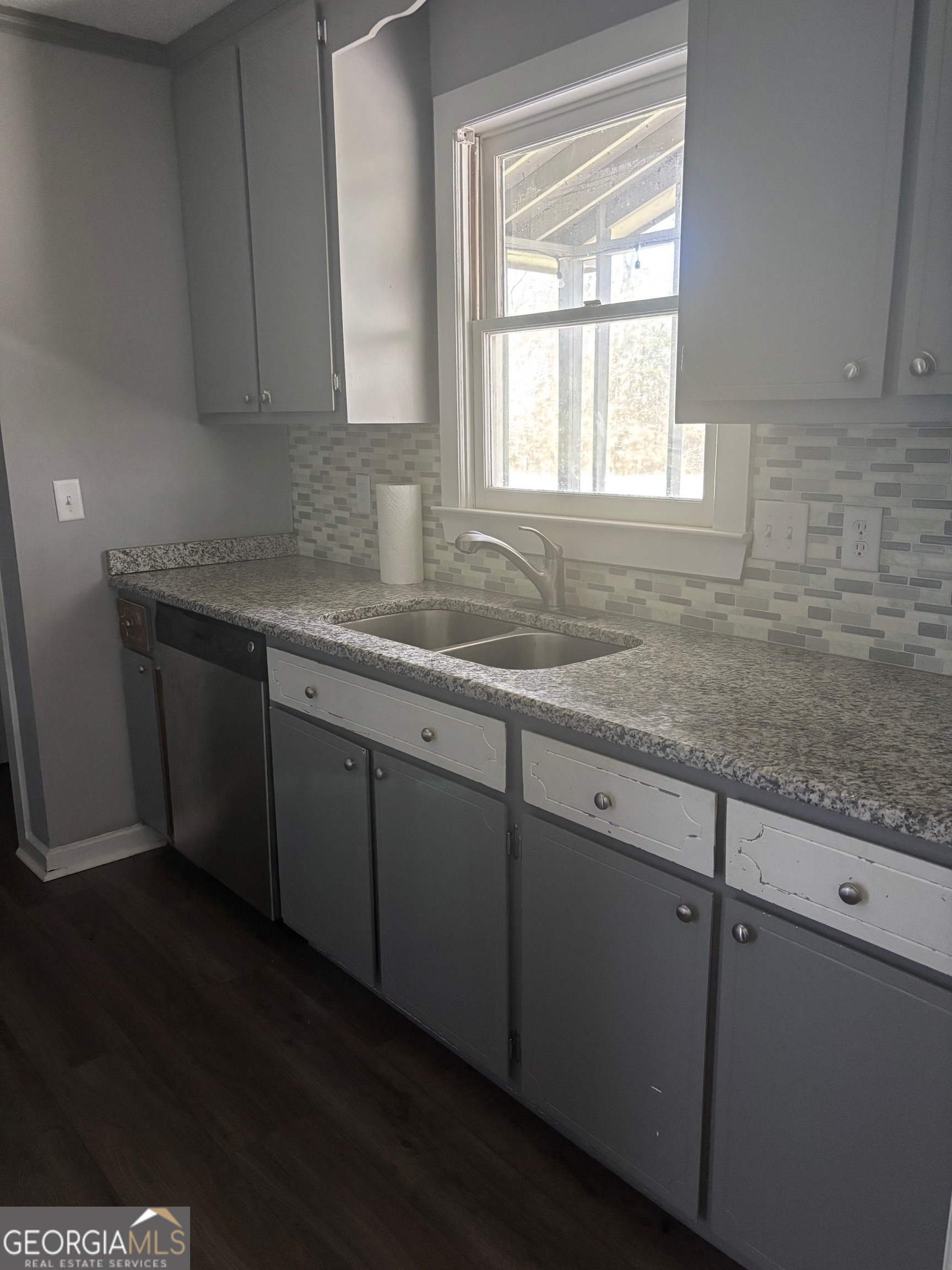 121 Girl Scout Road Lizella, GA 31052 - Photo 5 of 11 a kitchen with granite countertop cabinets sink and window