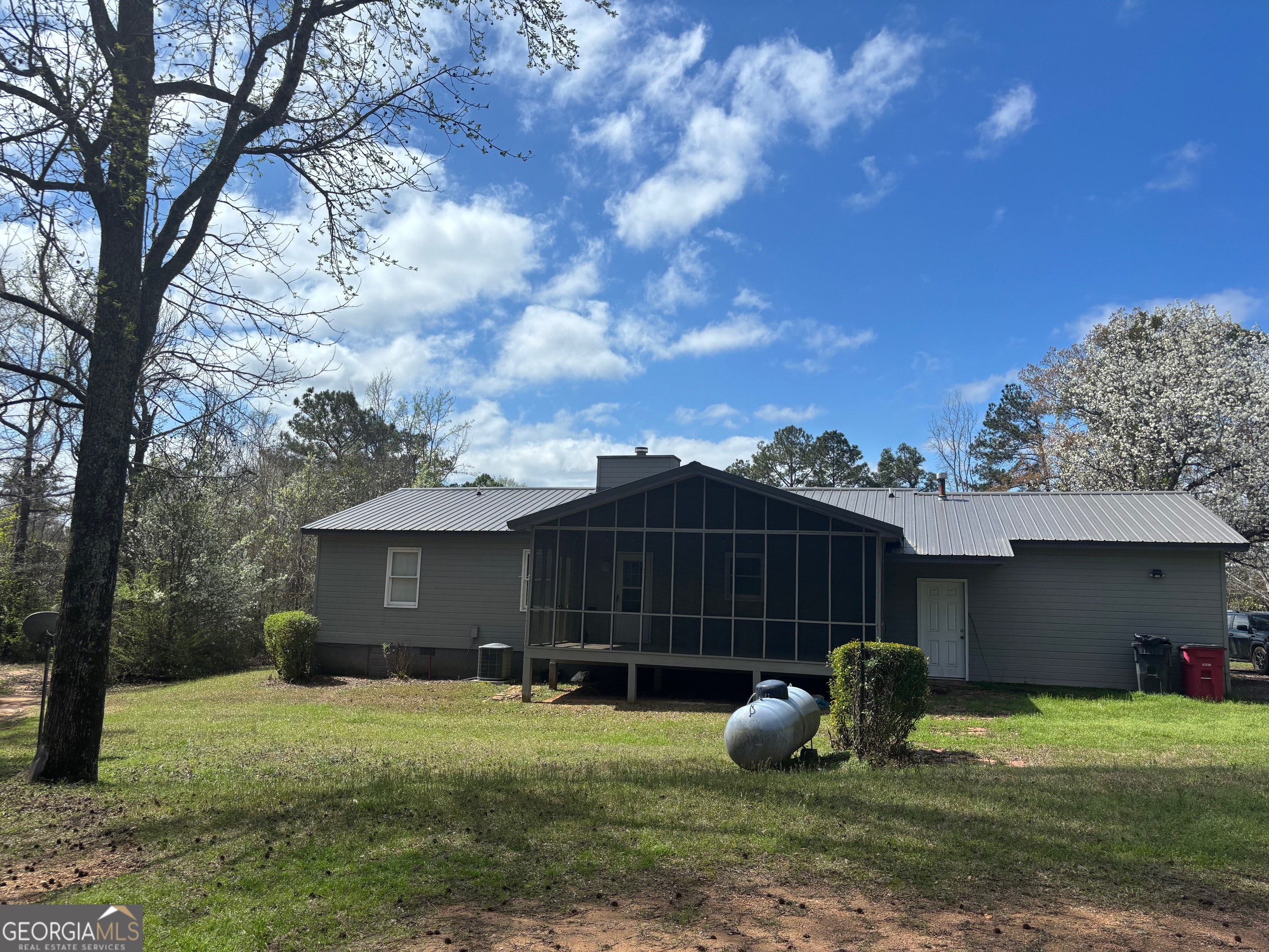 121 Girl Scout Road Lizella, GA 31052 - Photo 9 of 11 a backyard of a house with table and chairs