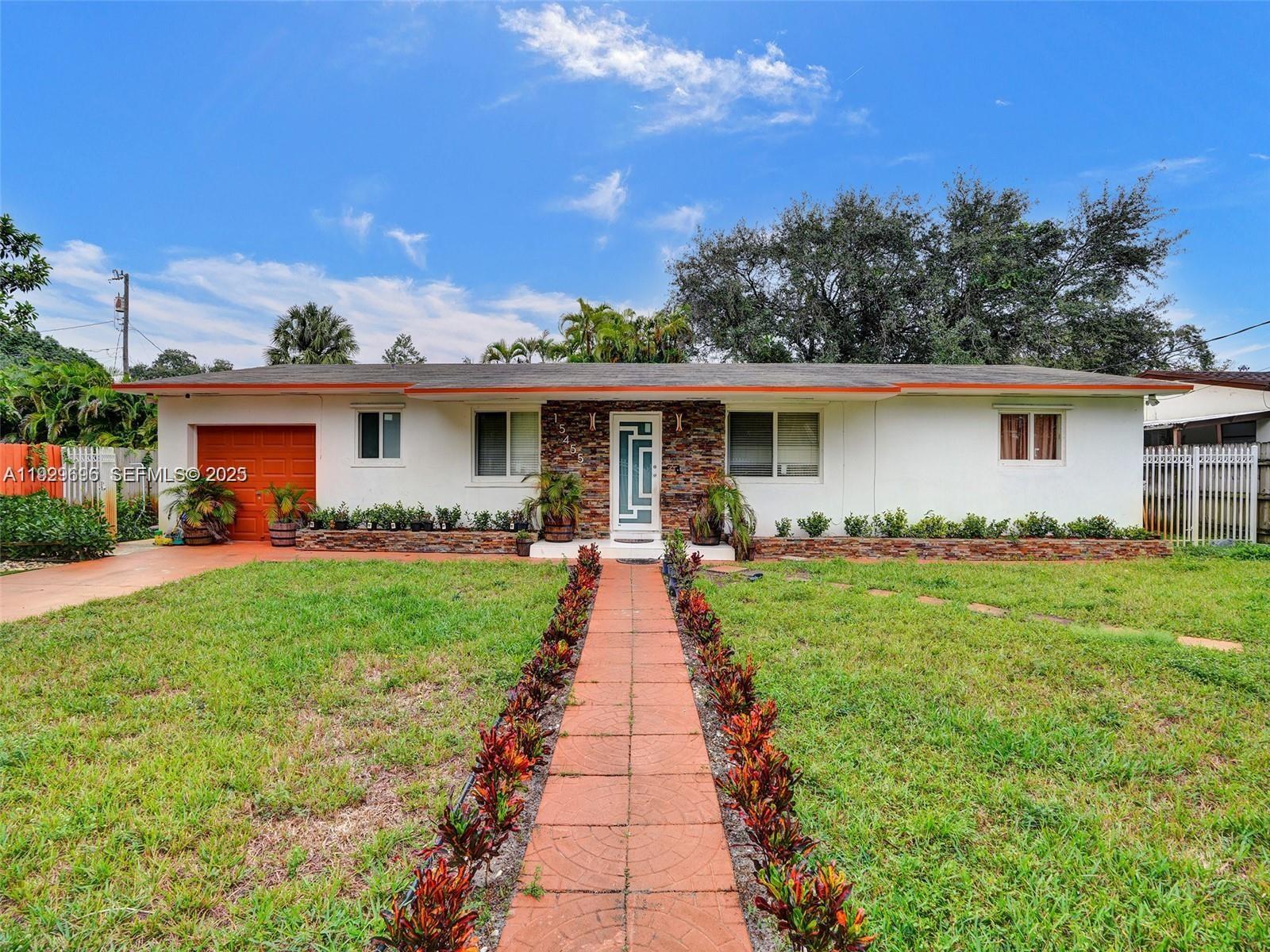 a front view of a house with yard patio and green space