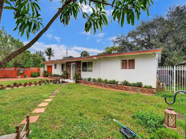 a front view of house with yard and outdoor seating