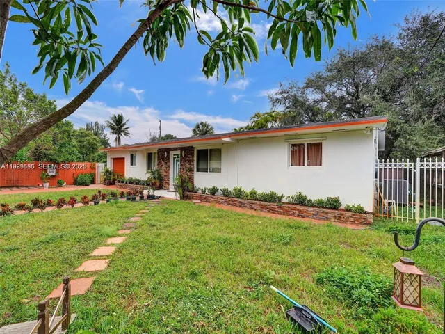 a front view of house with yard and outdoor seating